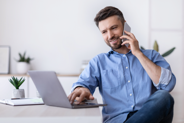 Luke Makes A Call While Looking On Laptop 600X400